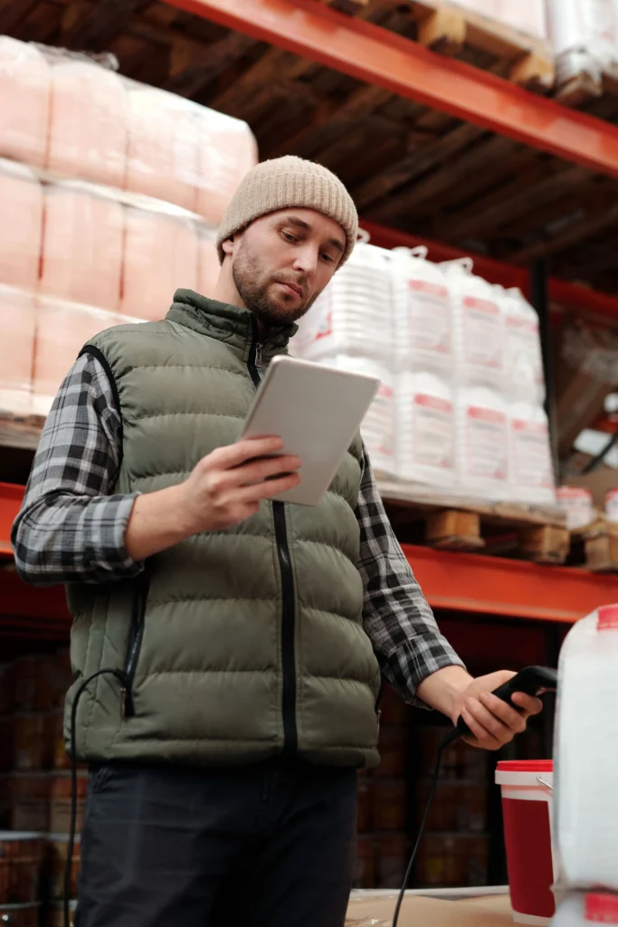 Moving From Pegasus Opera 3 To Microsoft Dynamics 365 Business Central: What Uk Businesses Need To Know Warehouse Employee Using A Tablet To Manage Inventory And Stock